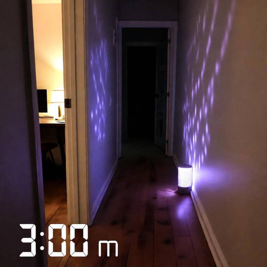 3 a.m. blurry iPhone shot of purple-pulsing hallway night-light.