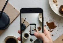 Mobile Tech News: The Best Phones, Apps, and Devices to Expect in 2025 Crooked desk photo with glowing 2025 phone, coffee ring, crumbs.