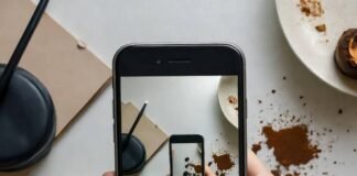 Mobile Tech News: The Best Phones, Apps, and Devices to Expect in 2025 Crooked desk photo with glowing 2025 phone, coffee ring, crumbs.